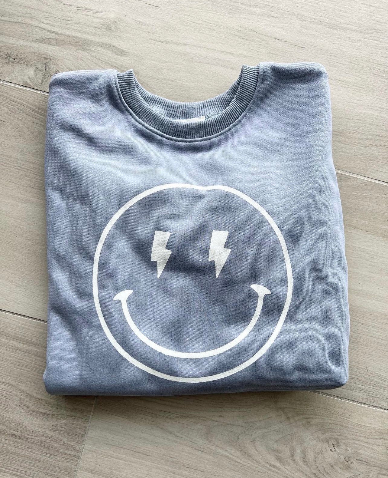 Blue lightning bolt smiley sweater